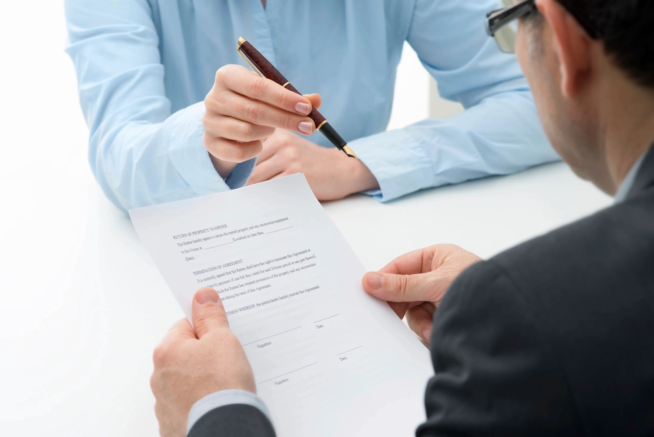 Business professionals signing documents